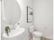 Modern bathroom features an updated sink and faucet, a round mirror, and neutral wall art at 219 Tillery Ln # 755, Mount Gilead, NC 27306