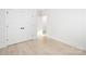Bright bedroom featuring pale wood floors, minimalist trim, and large closet doors at 219 Tillery Ln # 755, Mount Gilead, NC 27306