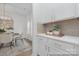 Dining area with stylish chandelier, table setting, and adjacent butler's pantry with white cabinetry, ideal for entertaining at 219 Tillery Ln # 755, Mount Gilead, NC 27306