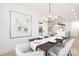 Elegant dining room with modern chandelier, table setting for six, light walls and trim at 219 Tillery Ln # 755, Mount Gilead, NC 27306