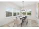 Bright dining room features large windows, modern chandelier, seating for six, and contemporary decor at 219 Tillery Ln # 755, Mount Gilead, NC 27306
