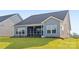 Exterior of home with a well-maintained backyard, screened in porch and tidy landscaping at 219 Tillery Ln # 755, Mount Gilead, NC 27306
