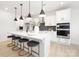 Modern kitchen features a large island with seating, white cabinets, stainless steel appliances, and stylish pendant lighting at 219 Tillery Ln # 755, Mount Gilead, NC 27306