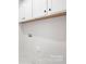 Functional laundry room with white cabinets, trim and convenient under-cabinet lighting at 219 Tillery Ln # 755, Mount Gilead, NC 27306