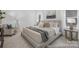 Calm primary bedroom with neutral tones, a comfortable king-size bed, and coordinated decor for a relaxing retreat at 219 Tillery Ln # 755, Mount Gilead, NC 27306