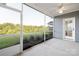 View from the screened porch to a lush, green lawn and treeline in the distance at 219 Tillery Ln # 755, Mount Gilead, NC 27306