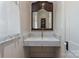 Bathroom featuring a marble countertop sink, decorative mirror, and wainscoted walls at 2268 New Gray Rock Rd, Fort Mill, SC 29708