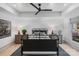 Bright bedroom showcasing a tray ceiling, ceiling fan, and symmetrical furniture layout at 2268 New Gray Rock Rd, Fort Mill, SC 29708