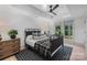 Well-lit bedroom boasts a tray ceiling, ceiling fan, and views of the backyard at 2268 New Gray Rock Rd, Fort Mill, SC 29708