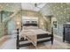 Bright bedroom with patterned wallpaper, a four-poster bed, and large windows with outside views at 2268 New Gray Rock Rd, Fort Mill, SC 29708