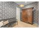 Foyer with patterned wallpaper, hardwood floors, a bench, and a vintage armoire at 2268 New Gray Rock Rd, Fort Mill, SC 29708