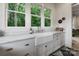 Bright kitchen features white cabinets, marble countertops and a farmhouse sink at 2268 New Gray Rock Rd, Fort Mill, SC 29708