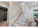 Bright stairway with hardwood floors and white railings leading to the upper level of the home with transom window at 2268 New Gray Rock Rd, Fort Mill, SC 29708
