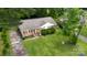 An elevated view of a charming single-story house with a well-kept lawn and mature trees at 2324 Knight Dr, Gastonia, NC 28052