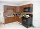 This kitchen features tile backsplash, range, and dark cabinetry in need of repair at 2324 Knight Dr, Gastonia, NC 28052