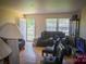 A comfortable living room featuring hardwood floors, a leather sofa, and natural light at 2324 Knight Dr, Gastonia, NC 28052
