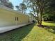 Expansive backyard featuring a well-manicured lawn and a covered patio with decorative string lights at 2469 Elkwood Cir, Charlotte, NC 28205