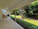Covered backyard patio with painted concrete and decorative string lights, overlooking the grassy lawn at 2469 Elkwood Cir, Charlotte, NC 28205