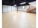 Spacious basement with painted ceiling, garage door access, and staircase leading to upper level at 2469 Elkwood Cir, Charlotte, NC 28205