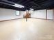 Basement area featuring stairs, painted concrete floor, and white painted brick wall at 2469 Elkwood Cir, Charlotte, NC 28205