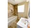 Bathroom features a stylish vanity, tub, and attractive neutral tile at 2469 Elkwood Cir, Charlotte, NC 28205