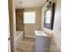 Bathroom features a stylish vanity, tub, and attractive neutral tile at 2469 Elkwood Cir, Charlotte, NC 28205
