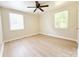 Bright bedroom with hardwood floors, a ceiling fan, and two windows at 2469 Elkwood Cir, Charlotte, NC 28205
