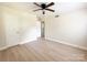 A spacious, light-filled bedroom with a ceiling fan and hardwood floors at 2469 Elkwood Cir, Charlotte, NC 28205