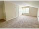 Cozy upstairs bedroom with a large carpeted floor and natural light at 2469 Elkwood Cir, Charlotte, NC 28205
