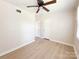 Bright bedroom with neutral walls, ceiling fan, and natural light at 2469 Elkwood Cir, Charlotte, NC 28205