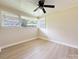 Bright bedroom with hardwood floors, a ceiling fan, and two windows at 2469 Elkwood Cir, Charlotte, NC 28205