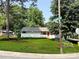 Well-maintained home with a vibrant green lawn, mature trees, and street sign view at 2469 Elkwood Cir, Charlotte, NC 28205