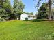 Well-maintained home with a vibrant green lawn and mature trees at 2469 Elkwood Cir, Charlotte, NC 28205
