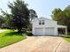 Two-car garage with a long driveway and lush green landscaping at 2469 Elkwood Cir, Charlotte, NC 28205
