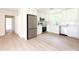 Bright kitchen with white cabinets, stainless steel appliances, and light flooring at 2469 Elkwood Cir, Charlotte, NC 28205