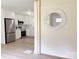 Open concept kitchen with white cabinets and brick accent wall with modern mirror at 2469 Elkwood Cir, Charlotte, NC 28205