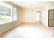 Open living room with large window, light flooring, and ample natural light at 2469 Elkwood Cir, Charlotte, NC 28205