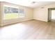 Bright, open living room with large windows and light colored floors providing an airy feel at 2469 Elkwood Cir, Charlotte, NC 28205