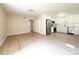 Open living and kitchen area with white cabinets and stainless steel appliances at 2469 Elkwood Cir, Charlotte, NC 28205