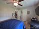 Bedroom with blue bedding, a ceiling fan, carpet flooring, and closet storage at 290 Greentree Dr, Rock Hill, SC 29730