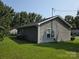 View of the home's side exterior and backyard with green grass and plentiful trees at 290 Greentree Dr, Rock Hill, SC 29730