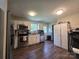 Kitchen with white cabinets, stainless steel appliances and luxury vinyl plank flooring at 290 Greentree Dr, Rock Hill, SC 29730
