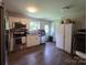 Bright kitchen with stainless steel appliances, white cabinets, and wood-look flooring at 290 Greentree Dr, Rock Hill, SC 29730