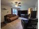 Cozy living room features a ceiling fan, a large window, and comfortable seating at 290 Greentree Dr, Rock Hill, SC 29730