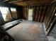 Bedroom featuring natural light and exposed framing ready for renovation at 306 E Arch St, Lancaster, SC 29720