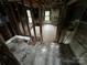 Bedroom featuring exposed framing and windows providing natural light ready for renovation at 306 E Arch St, Lancaster, SC 29720