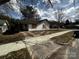 Quaint single story home with grass yard, carport and concrete driveway at 306 E Arch St, Lancaster, SC 29720