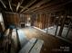 Spacious living room featuring exposed framing, fireplace, and original wood flooring ready for renovation at 306 E Arch St, Lancaster, SC 29720