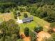 Aerial view of home featuring a private lot, complete with trees, outbuildings, and well manicured lawn at 330 Skyview Dr, Catawba, SC 29704