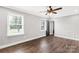 Well-lit bedroom features a ceiling fan, wood-look floors, and dual windows, creating a relaxing retreat at 330 Skyview Dr, Catawba, SC 29704